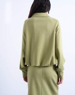 Model wearing Interlock bubble hem polo quarter zip sweat in green