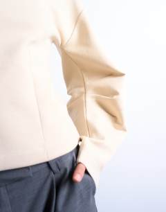 Model wearing Interlock cinch banana sleeve sweat in ecru