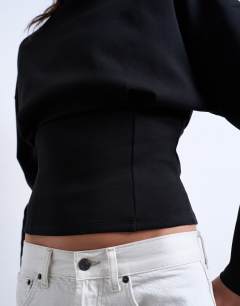 Model wearing Interlock corset waist long sleeve top in black