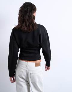 Model wearing Interlock corset waist long sleeve top in black