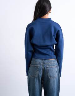 Model wearing Interlock corset waist long sleeve top in navy