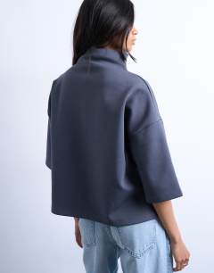 Model wearing Interlock funnel neck top in charcoal grey