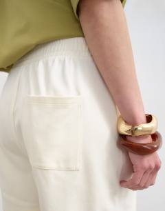 Model wearing Interlock jogger shorts co-ord in ecru