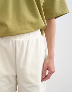 Model wearing Interlock jogger shorts co-ord in ecru