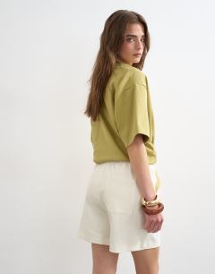 Model wearing Interlock jogger shorts co-ord in ecru