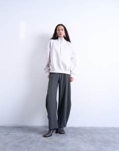 Model wearing Interlock long sleeve funnel neck zip sweat co-ord in stone