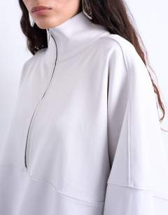 Model wearing Interlock long sleeve funnel neck zip sweat co-ord in stone