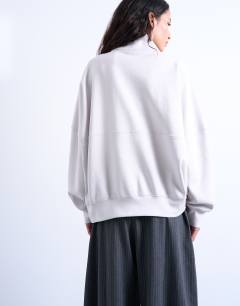 Model wearing Interlock long sleeve funnel neck zip sweat co-ord in stone