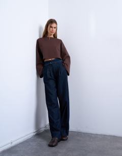 Model wearing Interlock long wide sleeve top in chocolate brown