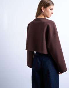 Model wearing Interlock long wide sleeve top in chocolate brown