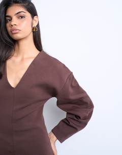 Model wearing Interlock v-neck banana sleeve tunic top in chocolate