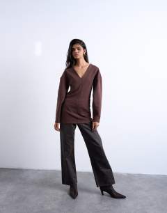 Model wearing Interlock v-neck banana sleeve tunic top in chocolate