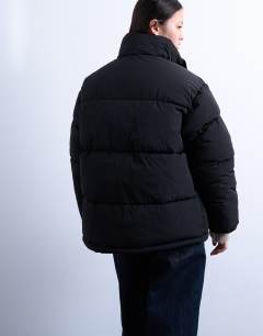 Model wearing Internal check funnel neck puffer jacket in black