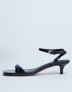 Model wearing Irene barely there mid heeled sandal in black