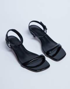 Model wearing Irene barely there mid heeled sandal in black