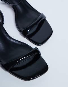 Model wearing Irene barely there mid heeled sandal in black