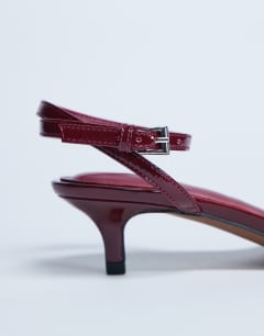 Model wearing Irene barely there mid heeled sandal in burgundy