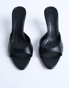 Model wearing Isaac point toe mule in black