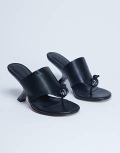 Model wearing Isai beaded toe thong heeled mule in black