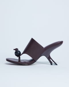 Model wearing Isai beaded toe thong high heeled mule in burgundy