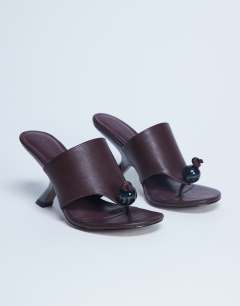Model wearing Isai beaded toe thong high heeled mule in burgundy