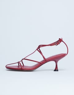 Model wearing Itzia strappy mid heel sandal in red