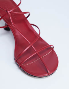 Model wearing Itzia strappy mid heel sandal in red