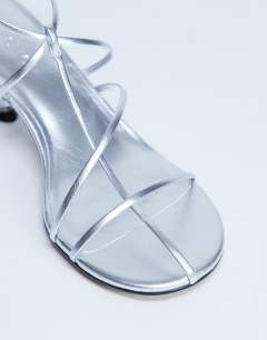 Model wearing Itzia strappy mid heel sandal in silver
