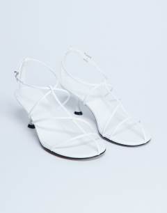 Model wearing Itzia strappy mid heel sandal in white