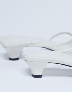 Model wearing Iva strappy kitten heel mule in white