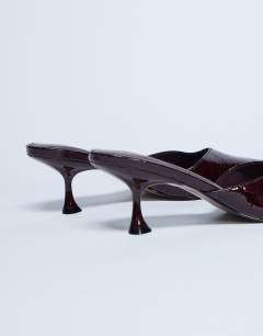 Model wearing Ivette croc patent close toe mule in burgundy