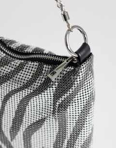 Model wearing Jackson embellished small shoulder bag in silver & grey tiger