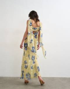 Model wearing Jacquard spot maxi occasion dress with open back in lemon and blue floral print