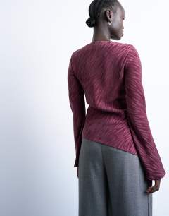 Model wearing Jacquard zebra slash neck long sleeve in burgundy