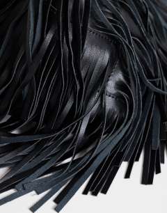 Model wearing Jada small fringe wristlet grab bag in black