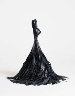 Model wearing Jada small fringe wristlet grab bag in black
