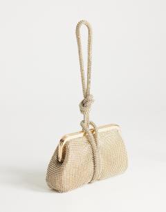 Model wearing Jade small wristlet grab bag in gold diamante