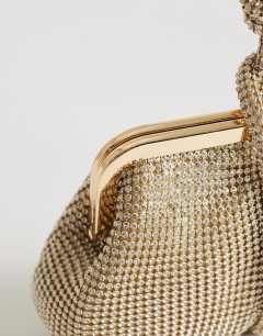 Model wearing Jade small wristlet grab bag in gold diamante