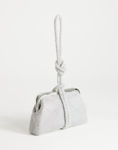 Model wearing Jade small wristlet grab bag in silver diamante