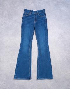 Model wearing Jamie flare high rise jean in rich blue