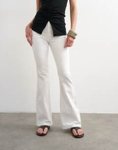 Model wearing Jamie Flare high rise jean in white