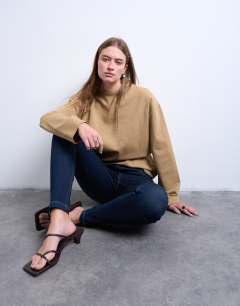 Model wearing Jamie high rise skinny jean in indigo rinse