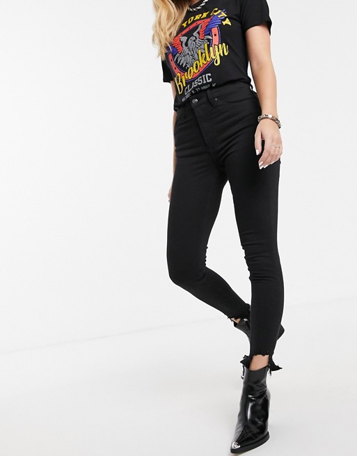 Topshop Jamie jeans with ripped hem in black