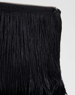 Model wearing Jasmine fringe envelope bag in black
