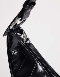 Model wearing Jasper medium scoop croc cross body bag in black