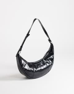 Model wearing Jasper medium scoop croc cross body bag in black