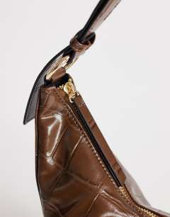 Model wearing Jasper medium scoop croc cross body bag in chocolate