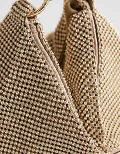 Model wearing Jax embellished asymmetric grab bag in gold
