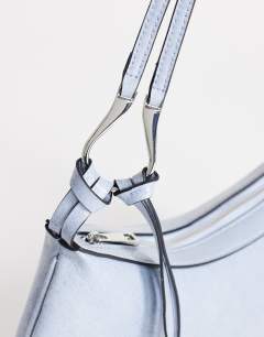 Model wearing Jaye small shoulder bag in blue