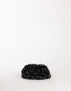 Model wearing Jemma beaded clutch bag in black and silver